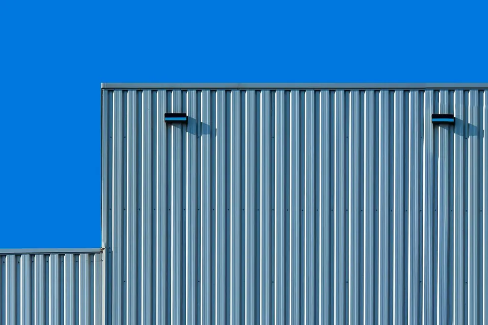 Corrugated metal industrial building against blue sky