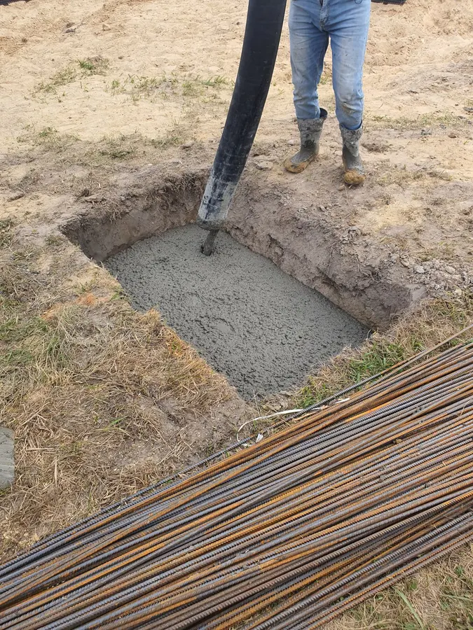 Concrete placed into a footing beside rebar